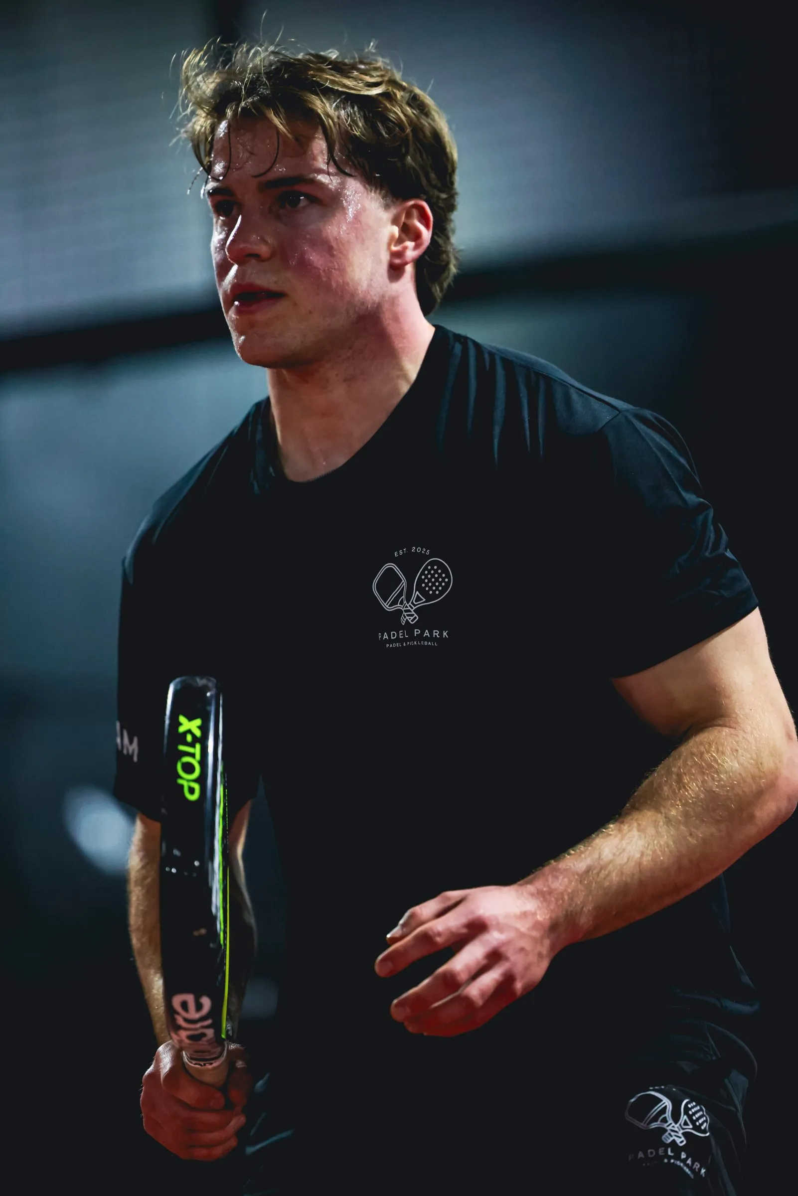 A Padel Park coach in the team tee on court
